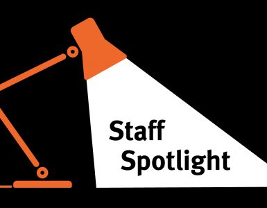 Lamp shining a spotlight on text that reads, staff spotlight