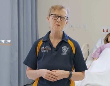 Sue Hampton standing in frame talking to camera